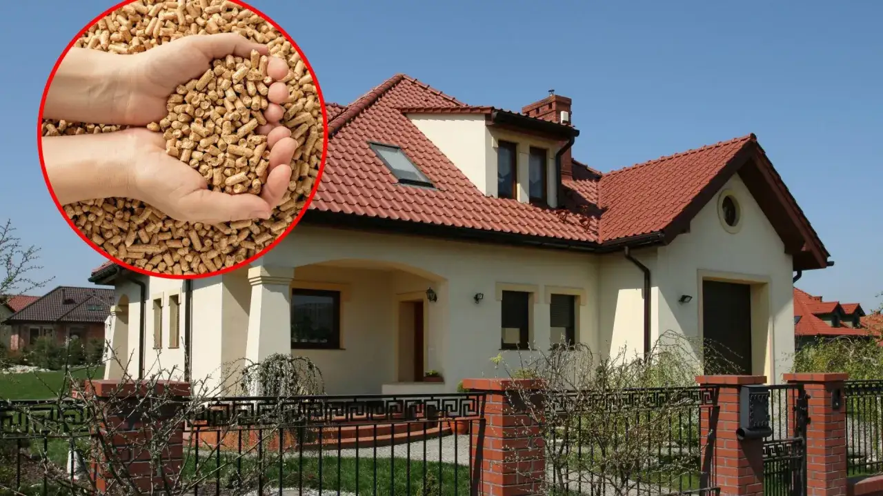 Dłonie trzymające pellet, symbol najlepszego ogrzewania domu, na tle nowoczesnej willi.