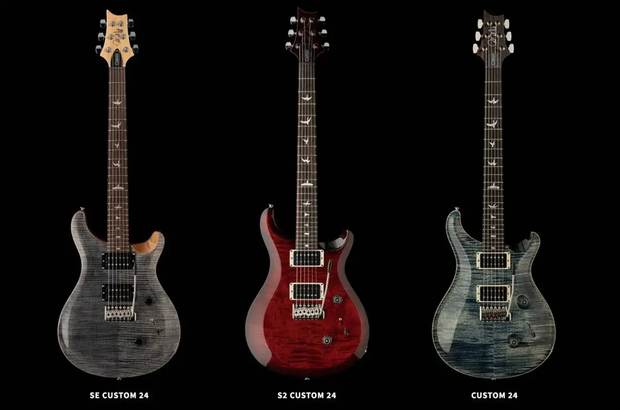 Trzy gitary PRS Custom 24: SE, S2 i Custom. Każda z nich ma charakterystyczne ptaki na podstrunnicy.
